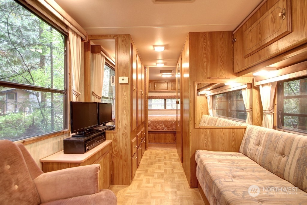 90-2 Wilderness Way Maple Falls, WA 98266 - Photo 5 of 39 a living room with furniture a flat screen tv and a floor to ceiling window
