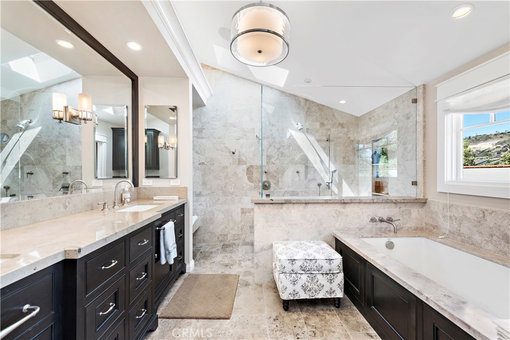 4 Monarch Bay Drive Dana Point, CA 92629 - Photo 17 of 34 a spacious bathroom with a double vanity sink mirror and bathtub
