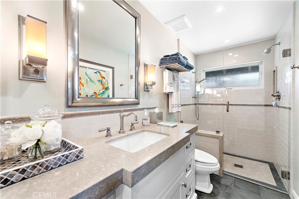 4 Monarch Bay Drive Dana Point, CA 92629 - Photo 25 of 34 a bathroom with a granite countertop sink mirror vanity and toilet