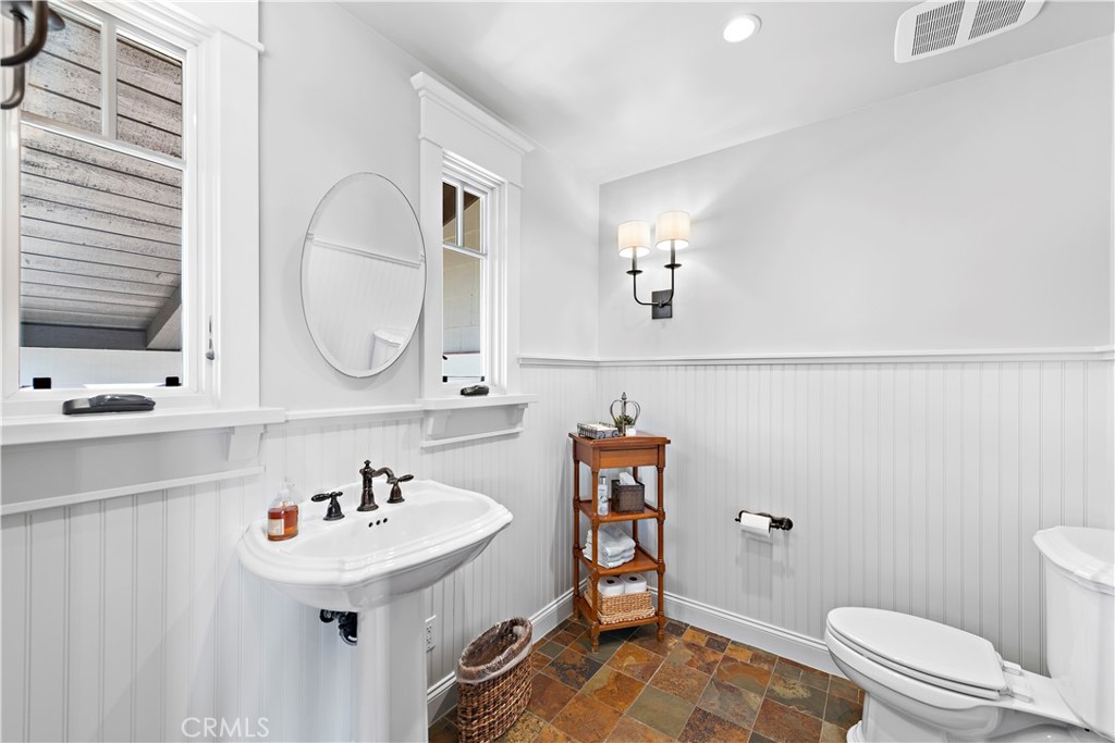 4 Monarch Bay Drive Dana Point, CA 92629 - Photo 26 of 34 a bathroom with a sink a toilet and a mirror