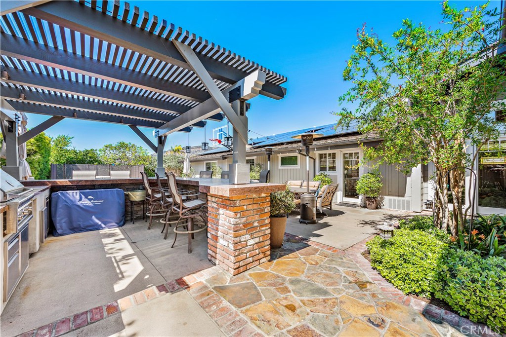 4 Monarch Bay Drive Dana Point, CA 92629 - Photo 29 of 34 a view of a patio with table and chairs potted plants and large tree