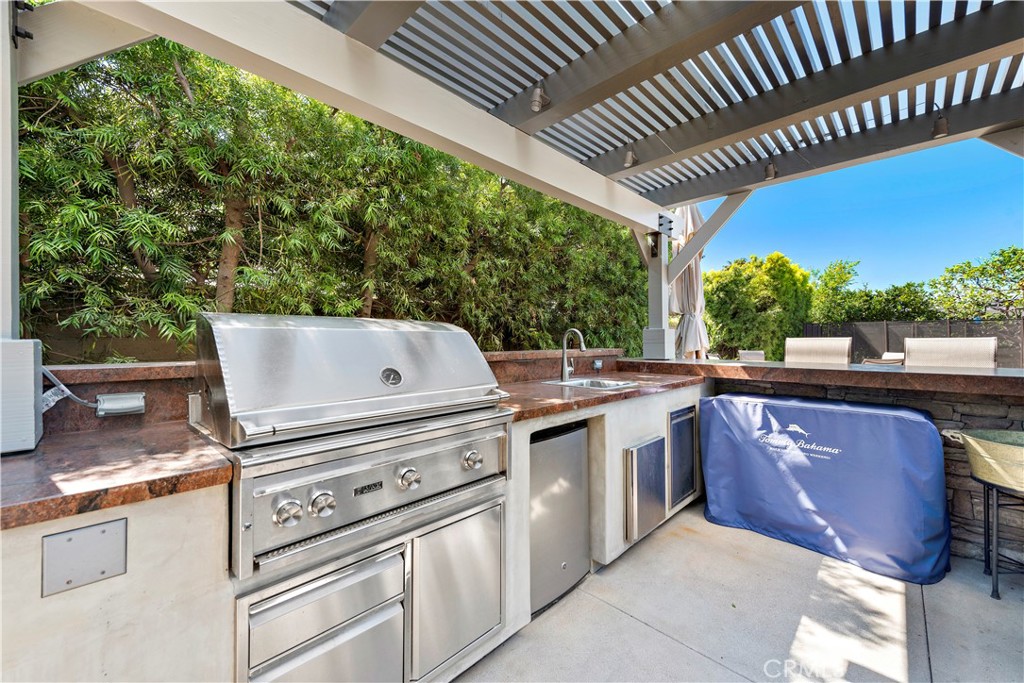 4 Monarch Bay Drive Dana Point, CA 92629 - Photo 30 of 34 a view of a patio with table and chairs with wooden floor and fence