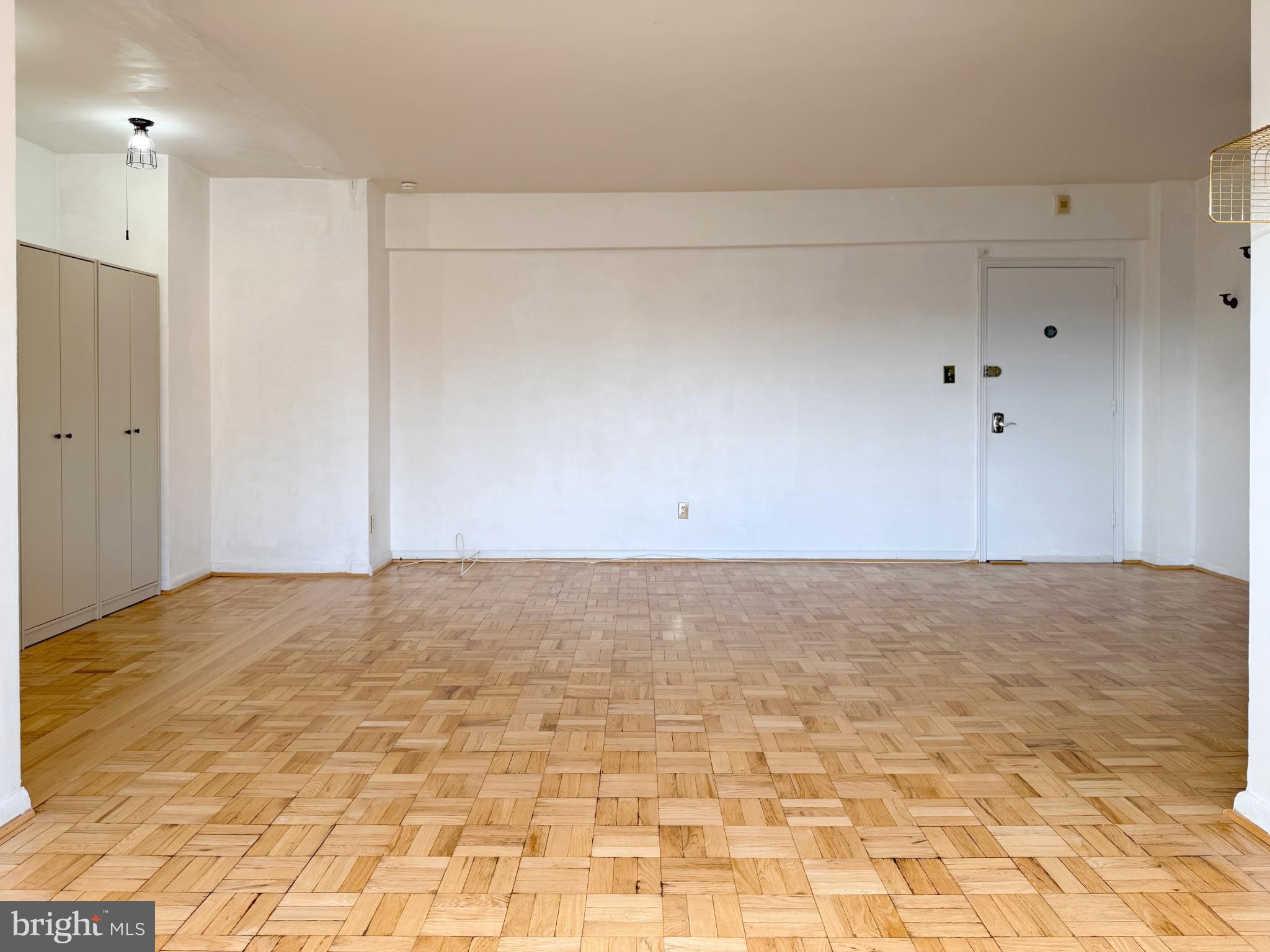 2500 Q Street Northwest, Unit 529 Washington, DC 20007 - Photo 14 of 29 Spacious, sunlit room with polished floors.