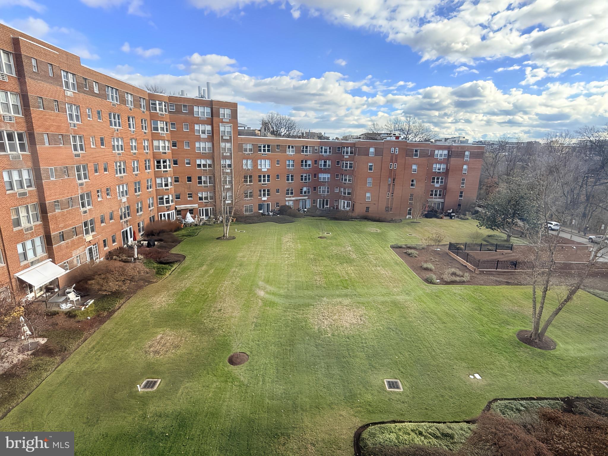 2500 Q Street Northwest, Unit 529 Washington, DC 20007 - Photo 29 of 29 Spacious green courtyard under a blue sky.