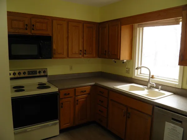 a kitchen with a sink stove and microwave