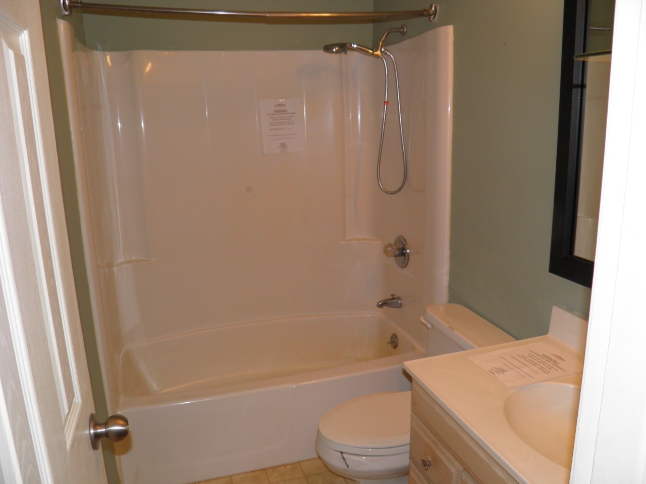 2264 Ridgeview Drive Muscatine, IA 52761 - Photo 18 of 33 a bathroom with a granite countertop bathtub shower sink vanity and toilet