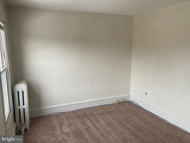 a view of an empty room and a window