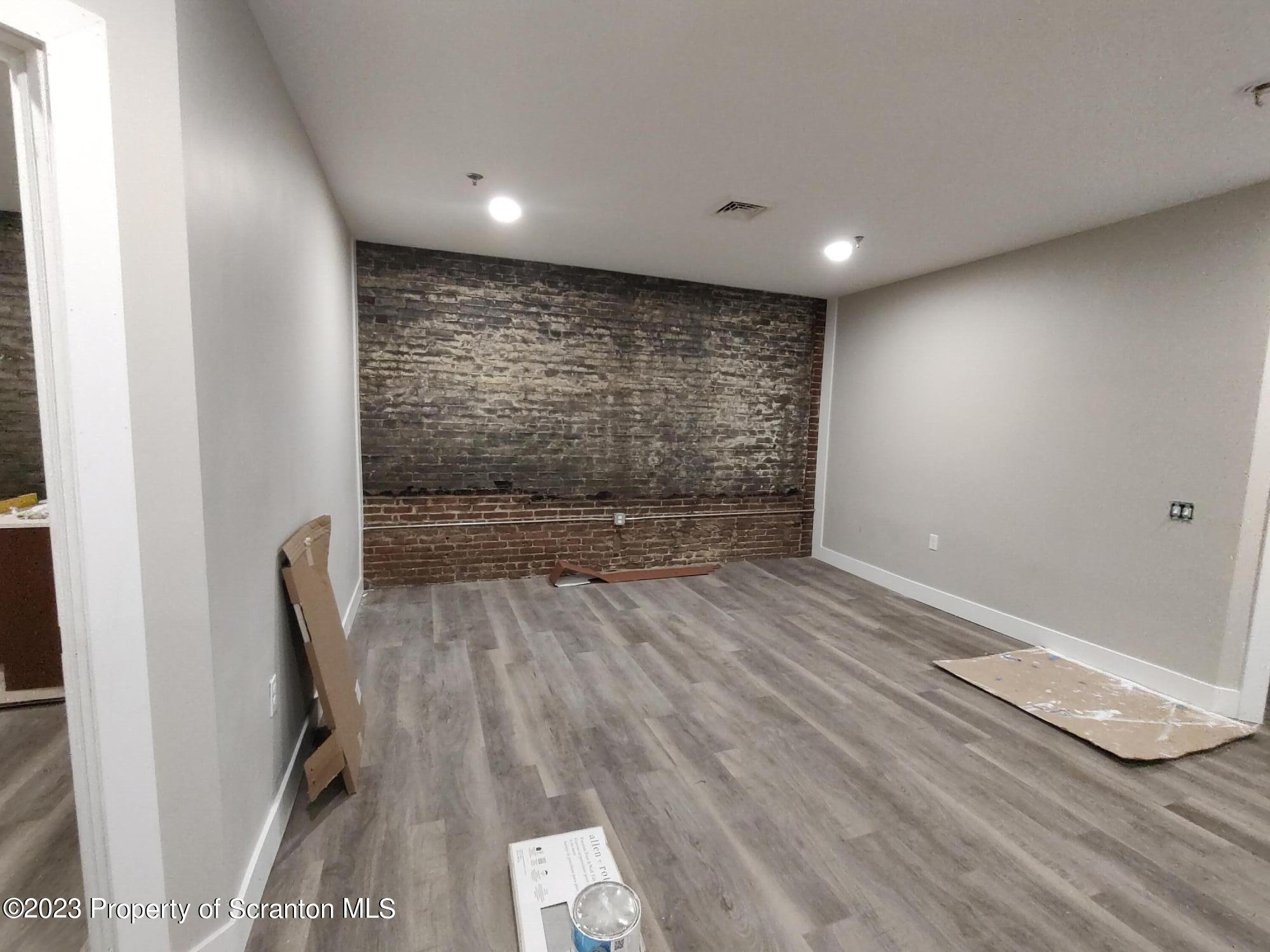 205 North Washington Avenue, Unit 7 Scranton, PA 18503 - Photo 2 of 6 an empty room with wooden floor and windows