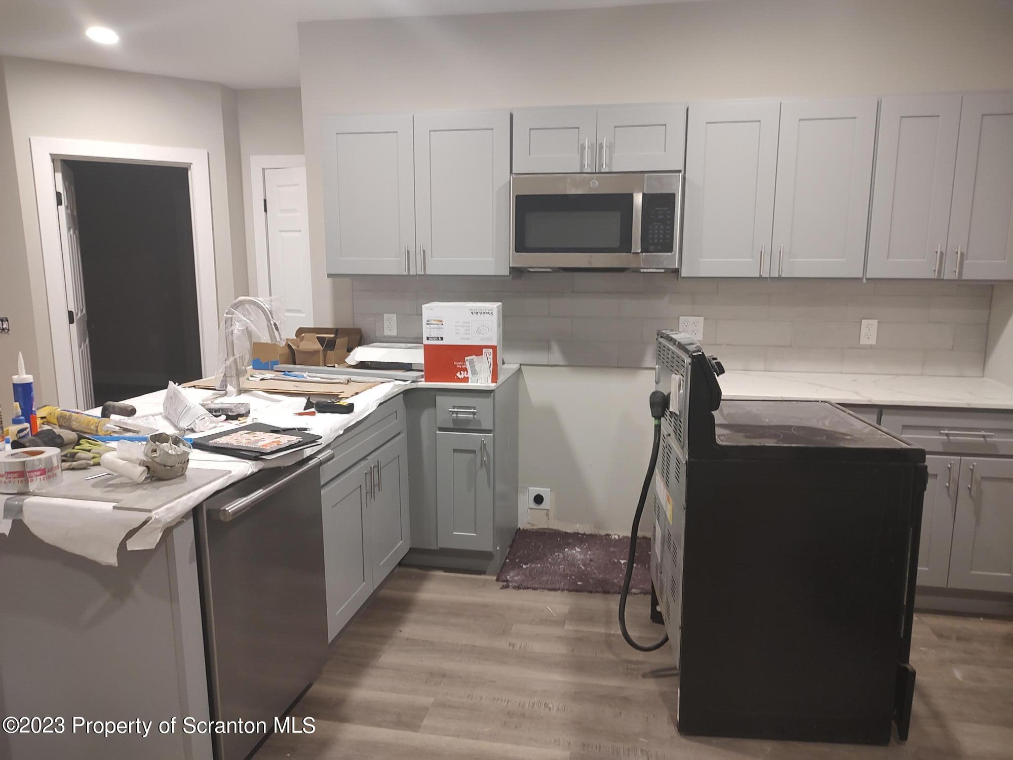 205 North Washington Avenue, Unit 7 Scranton, PA 18503 - Photo 3 of 6 a kitchen with a sink appliances and cabinets