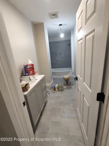 a bathroom with a sink vanity and mirror
