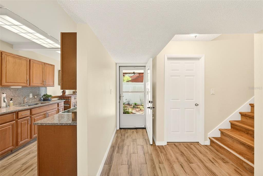 2064 Sunset Point Road, Unit 73 Clearwater, FL 33765 - Photo 7 of 58 a kitchen with wooden floor and cabinets