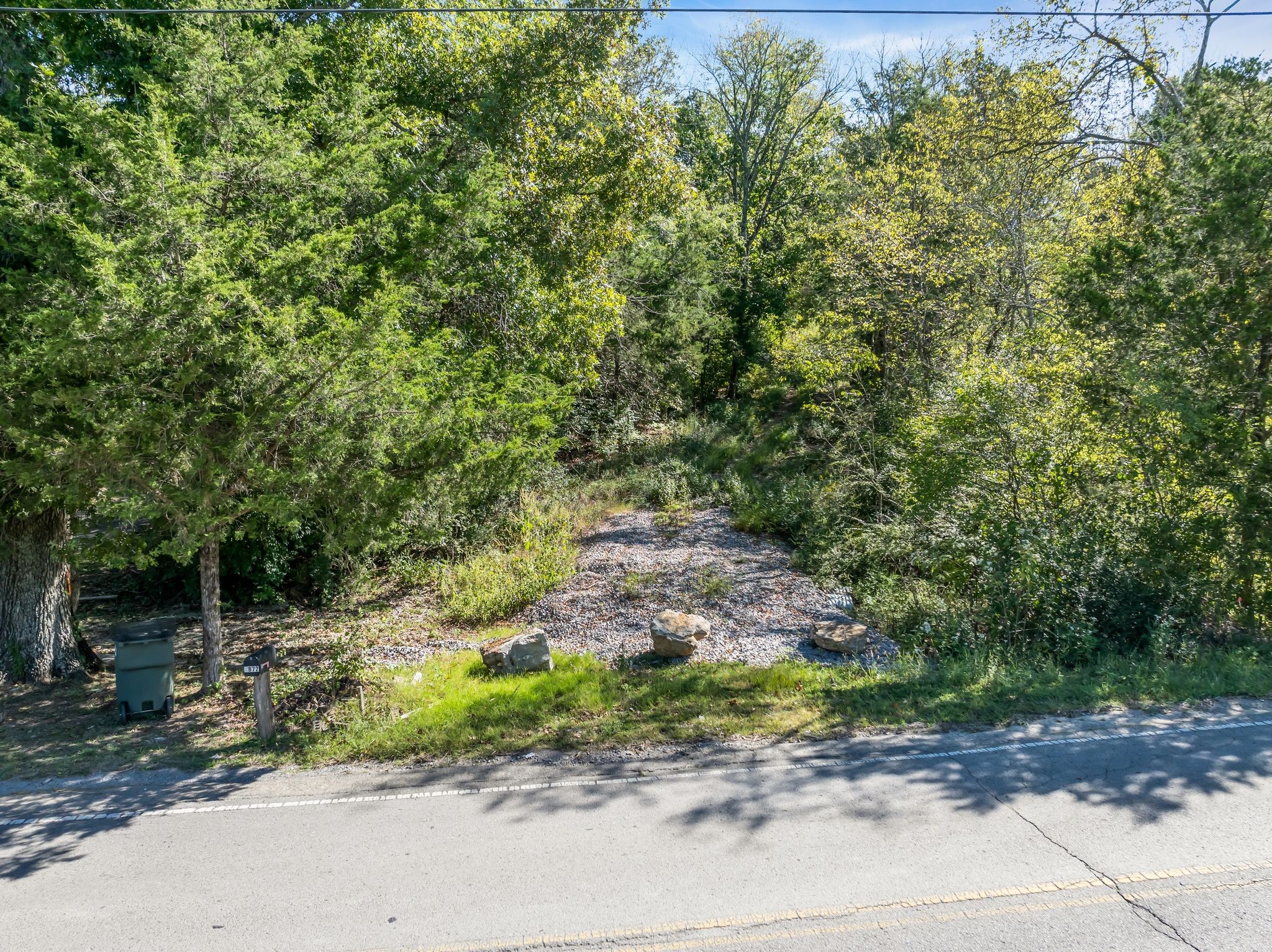 5882 Cane Ridge Road Antioch, TN 37013 - Photo 16 of 17 a view of a road with plants and large trees