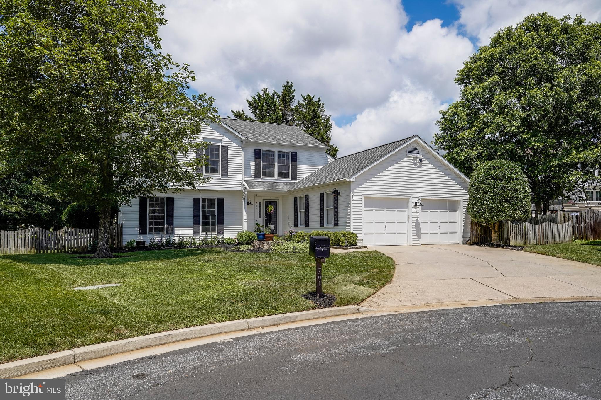 701 Stratford Manor Terrace Silver Spring, MD 20905 - Photo 2 of 43 a front view of a house with a garden and trees