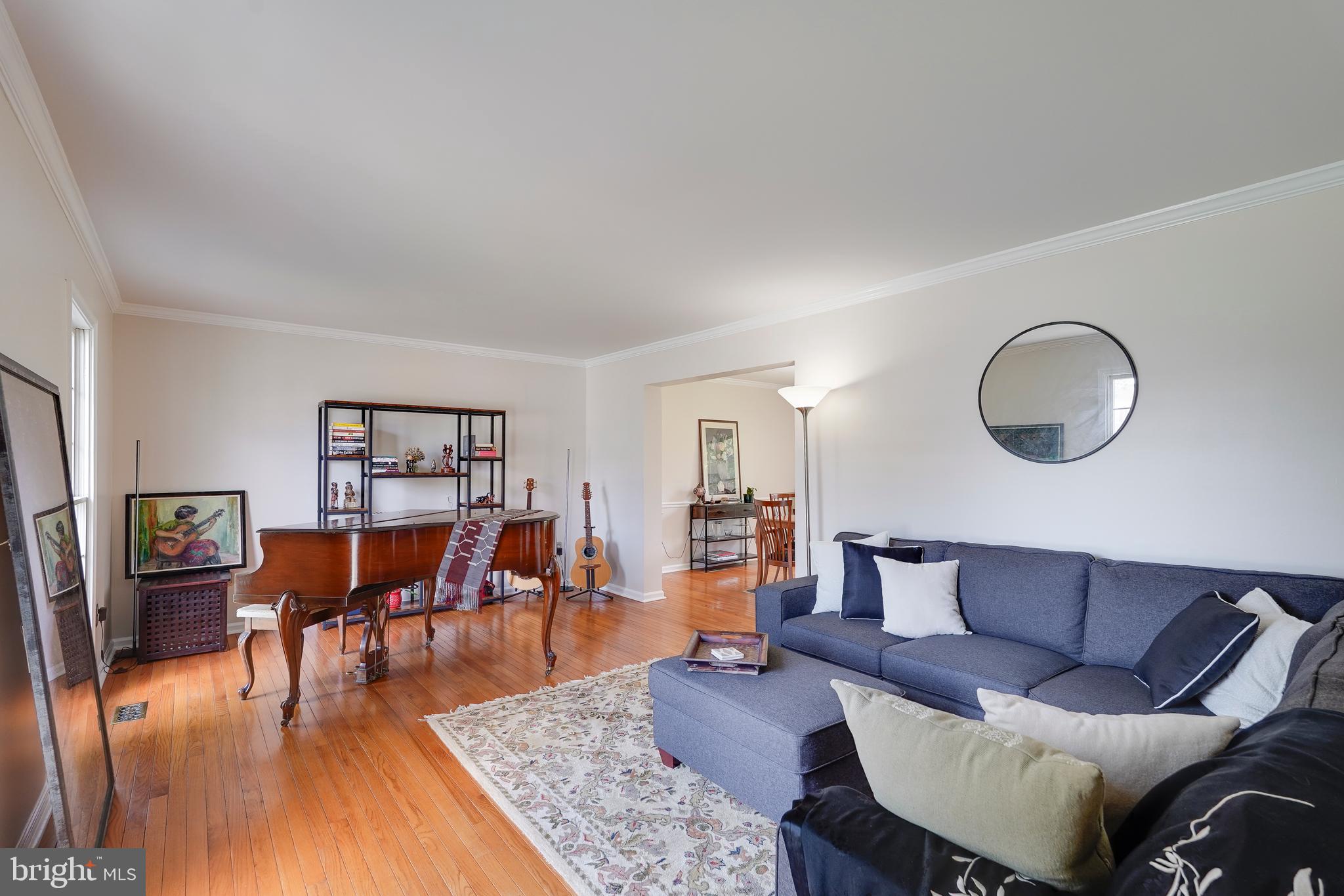 701 Stratford Manor Terrace Silver Spring, MD 20905 - Photo 5 of 43 a living room with furniture and a wooden floor
