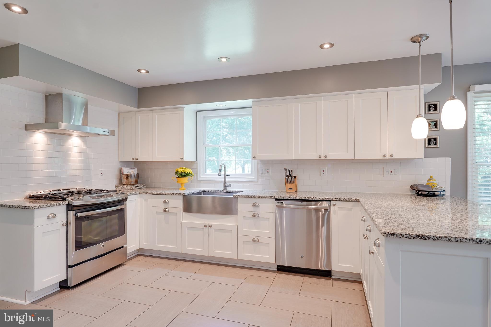 701 Stratford Manor Terrace Silver Spring, MD 20905 - Photo 9 of 43 a kitchen with granite countertop white cabinets and appliances