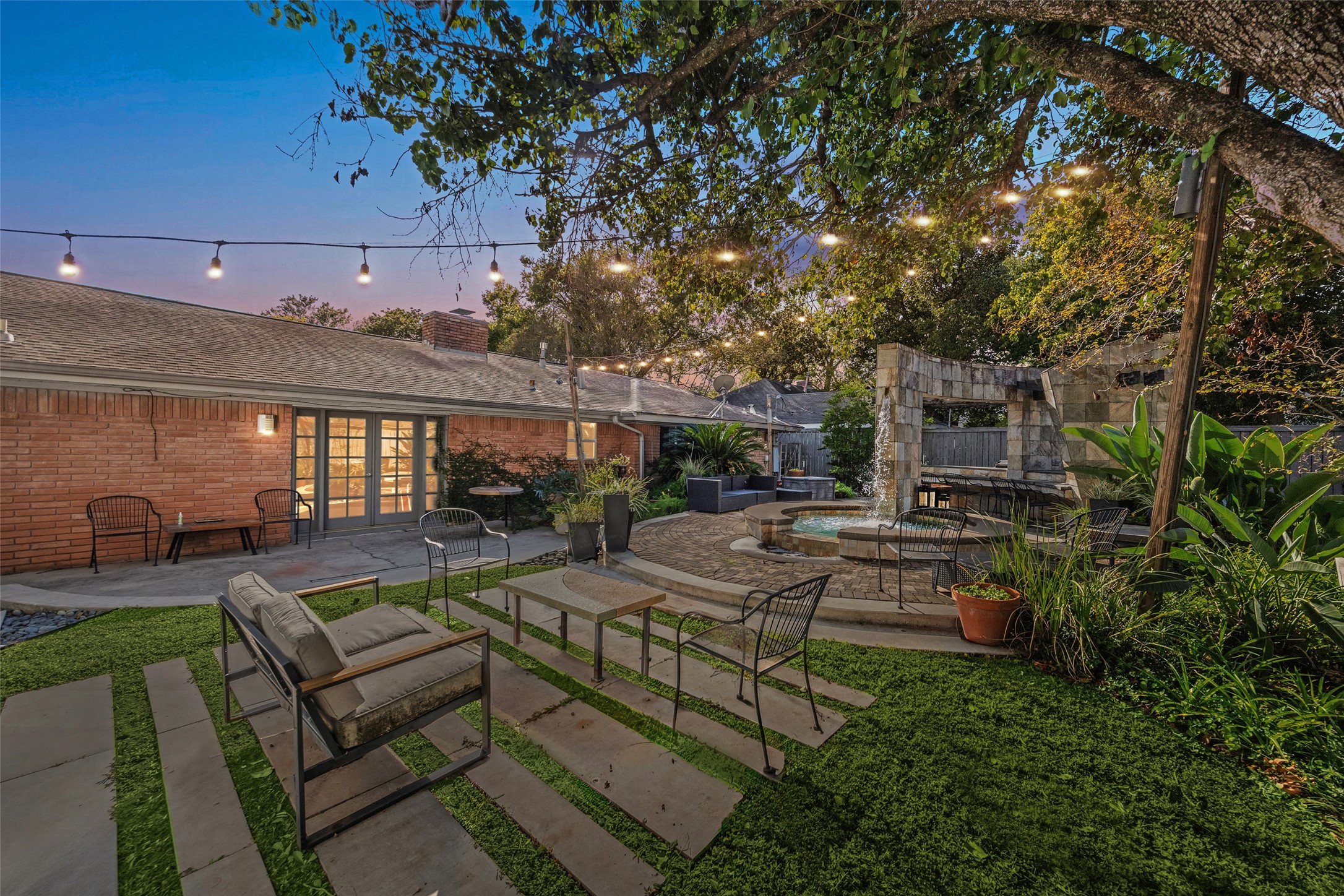 a view of backyard with seating area and green space