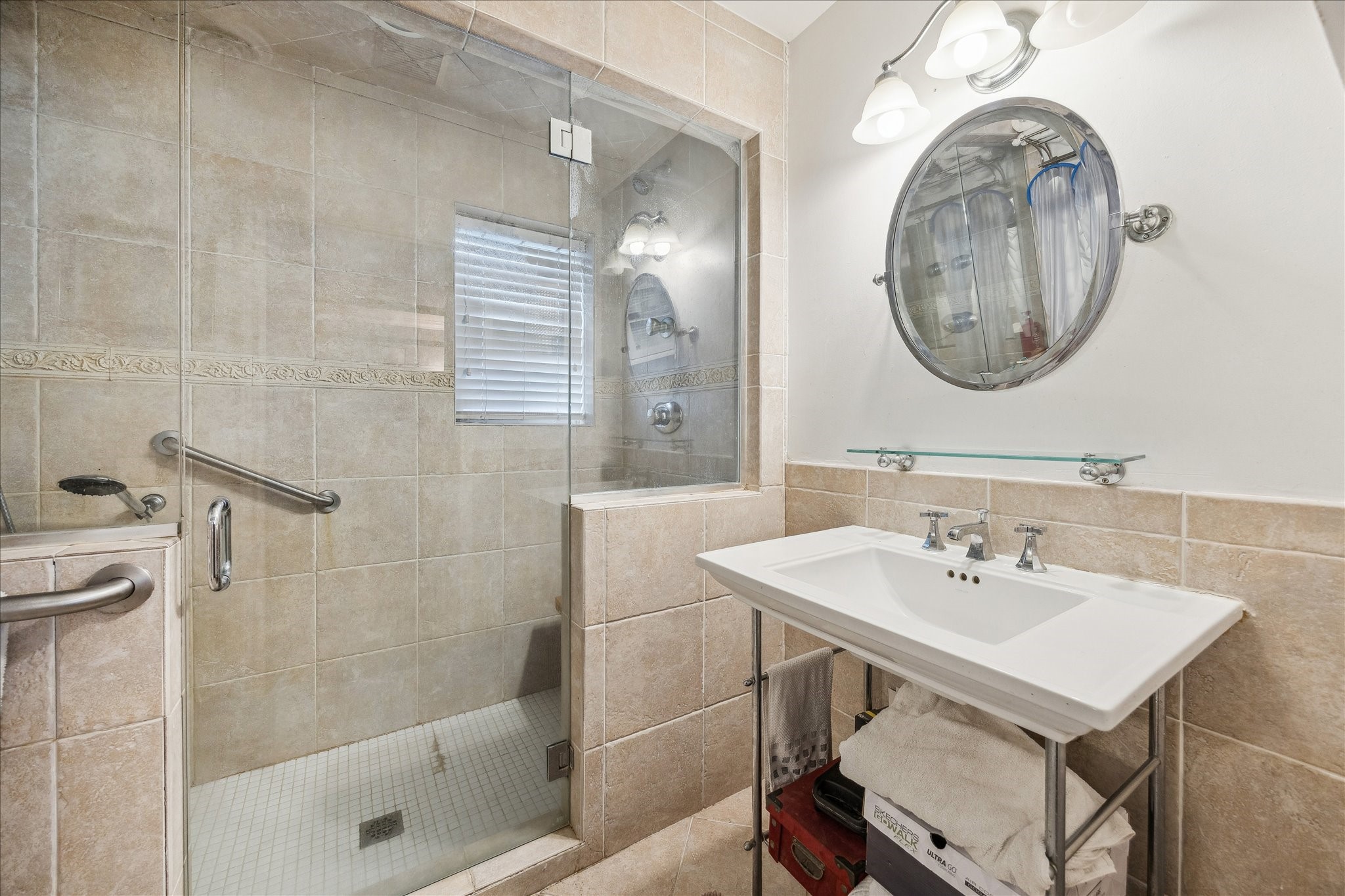 10102 Knoboak Drive Houston, TX 77080 - Photo 23 of 39 a bathroom with a sink a mirror and a shower