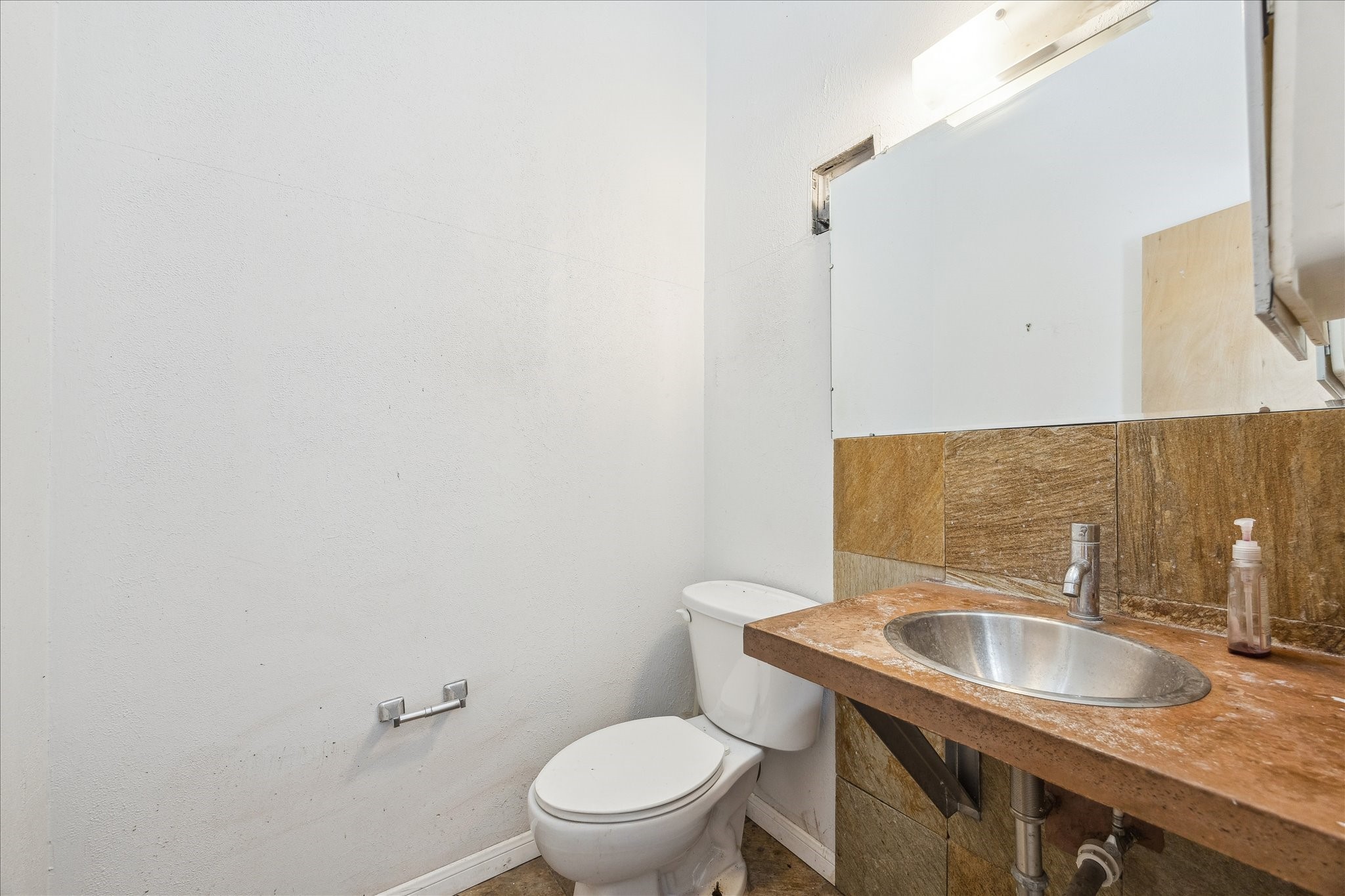 10102 Knoboak Drive Houston, TX 77080 - Photo 29 of 39 a bathroom with a granite countertop toilet sink and mirror