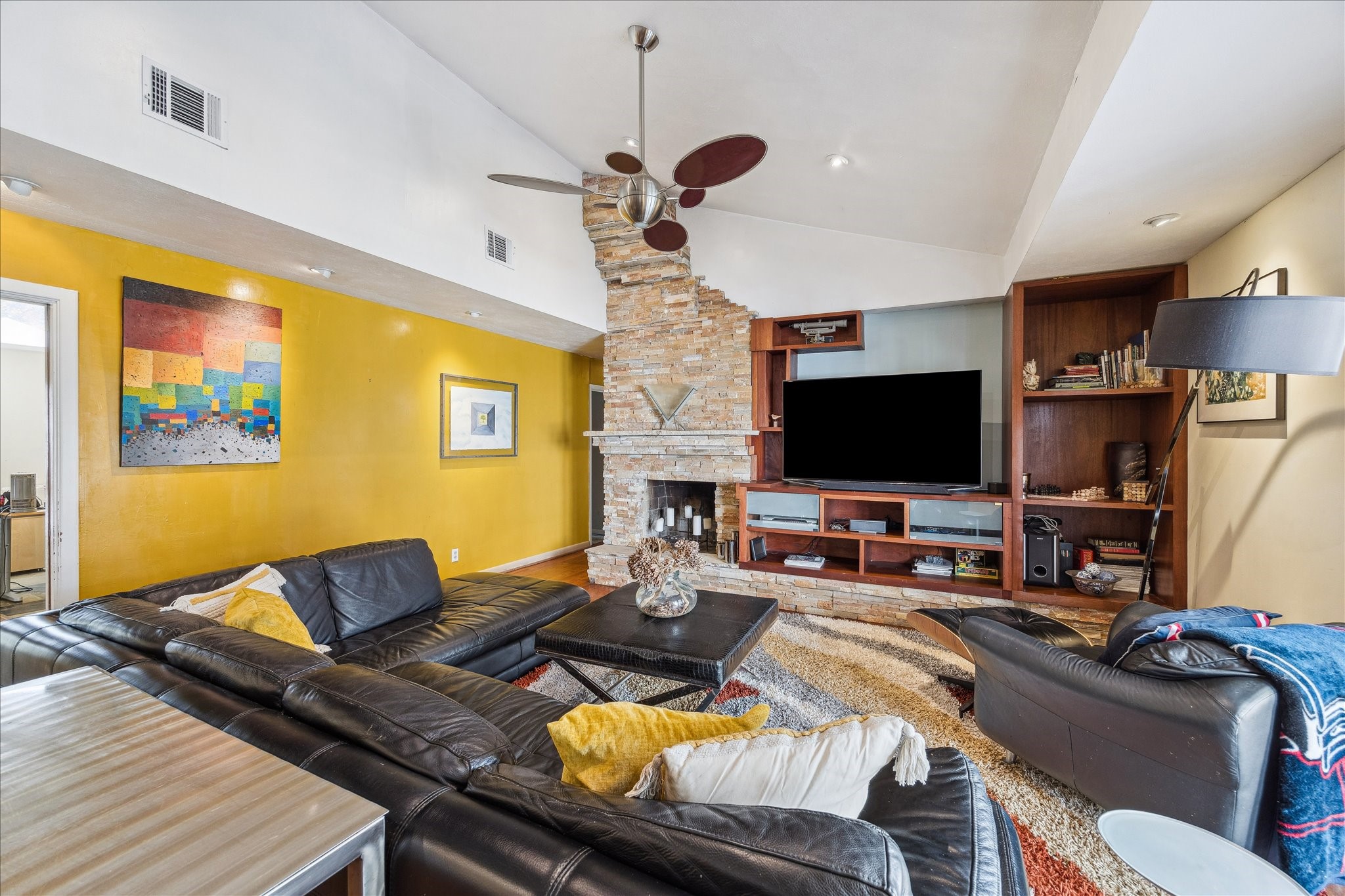 10102 Knoboak Drive Houston, TX 77080 - Photo 10 of 39 a living room with furniture a flat screen tv and a fireplace