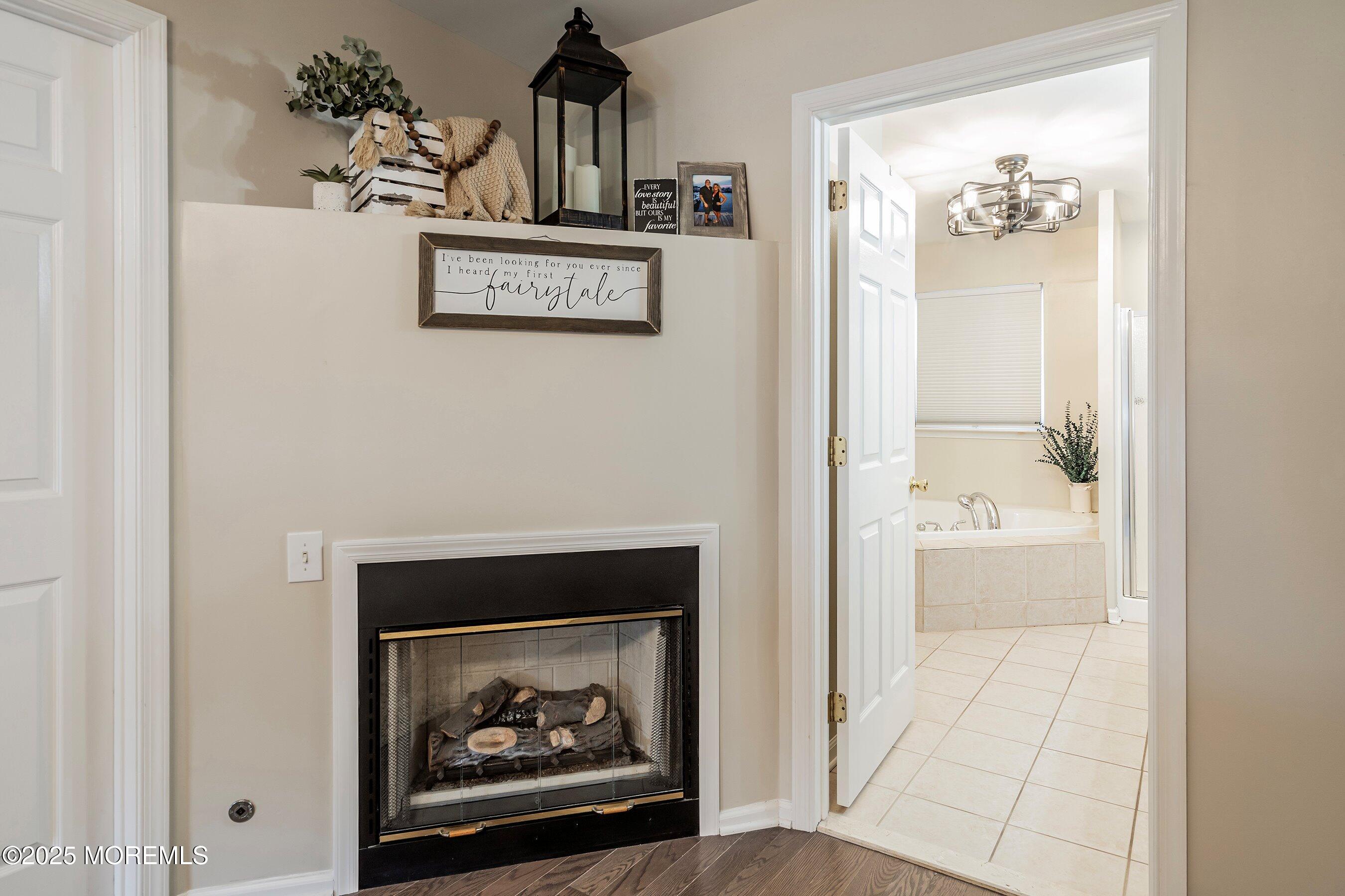 124 Barracuda Road Manahawkin, NJ 08050 - Photo 36 of 69 a view of a hallway with wooden floor and a fireplace