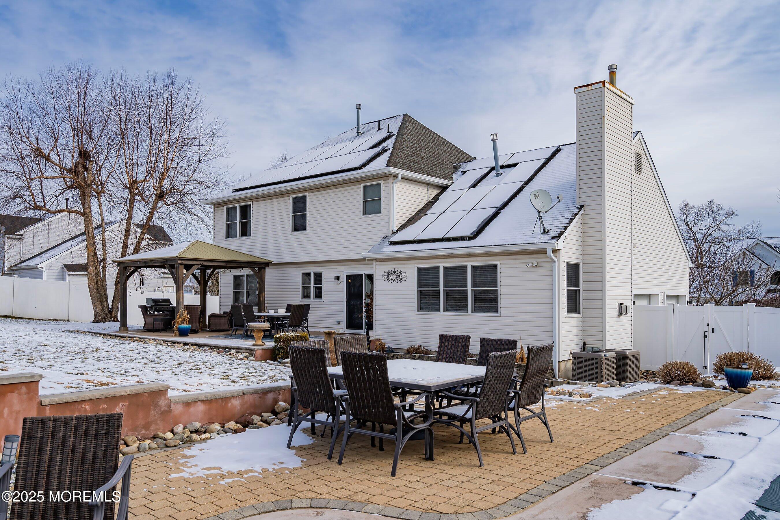 124 Barracuda Road Manahawkin, NJ 08050 - Photo 49 of 69 a view of a patio with table and chairs