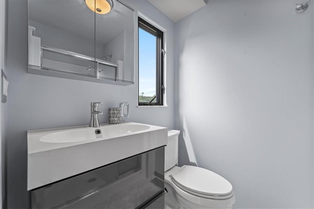 207 Ridge Avenue Freedom, PA 15042 - Photo 28 of 49 a bathroom with a toilet a sink and mirror