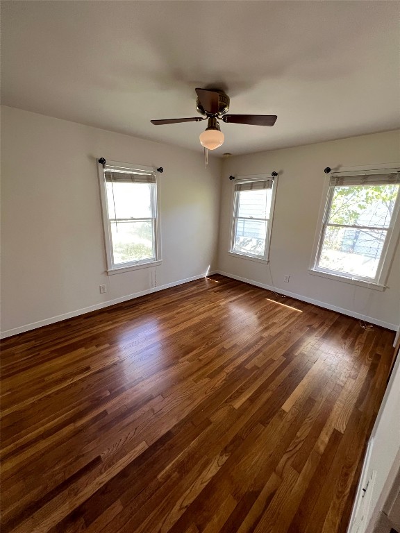 1908 Aggie Lane Austin, TX 78757 - Photo 5 of 11 an empty room with wooden floor and windows