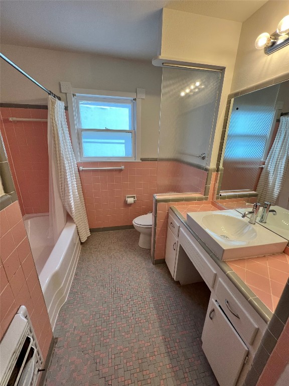 1908 Aggie Lane Austin, TX 78757 - Photo 8 of 11 a bathroom with a double vanity sink a toilet and a mirror