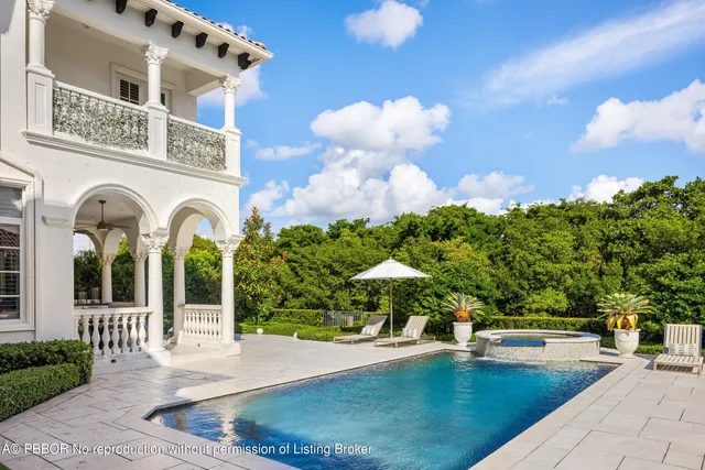 a view of a house with swimming pool and sitting area