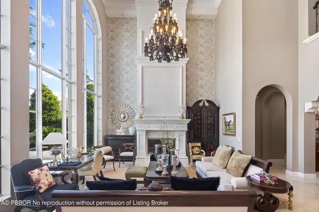 a living room with fireplace furniture and a large mirror