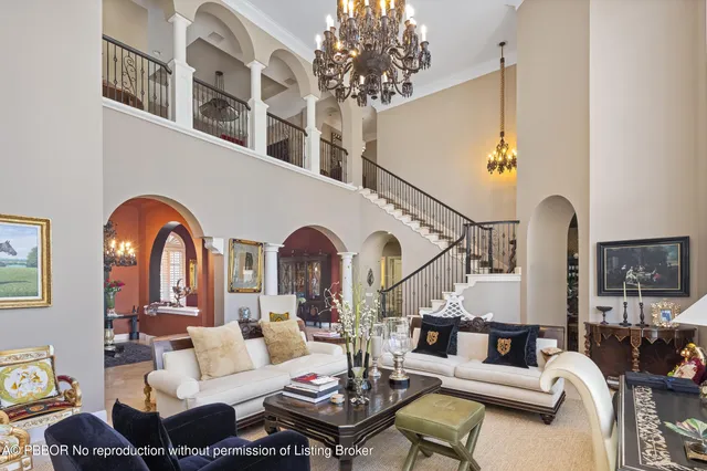 a living room with furniture a rug and a chandelier