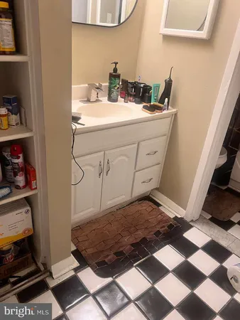 a bathroom with a toilet sink and mirror