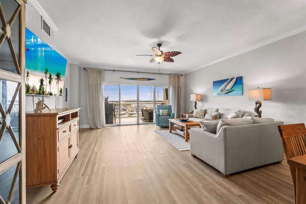 425 150th Avenue, Unit 2303 Madeira Beach, FL 33708 - Photo 16 of 69 a living room with furniture and a wooden floor