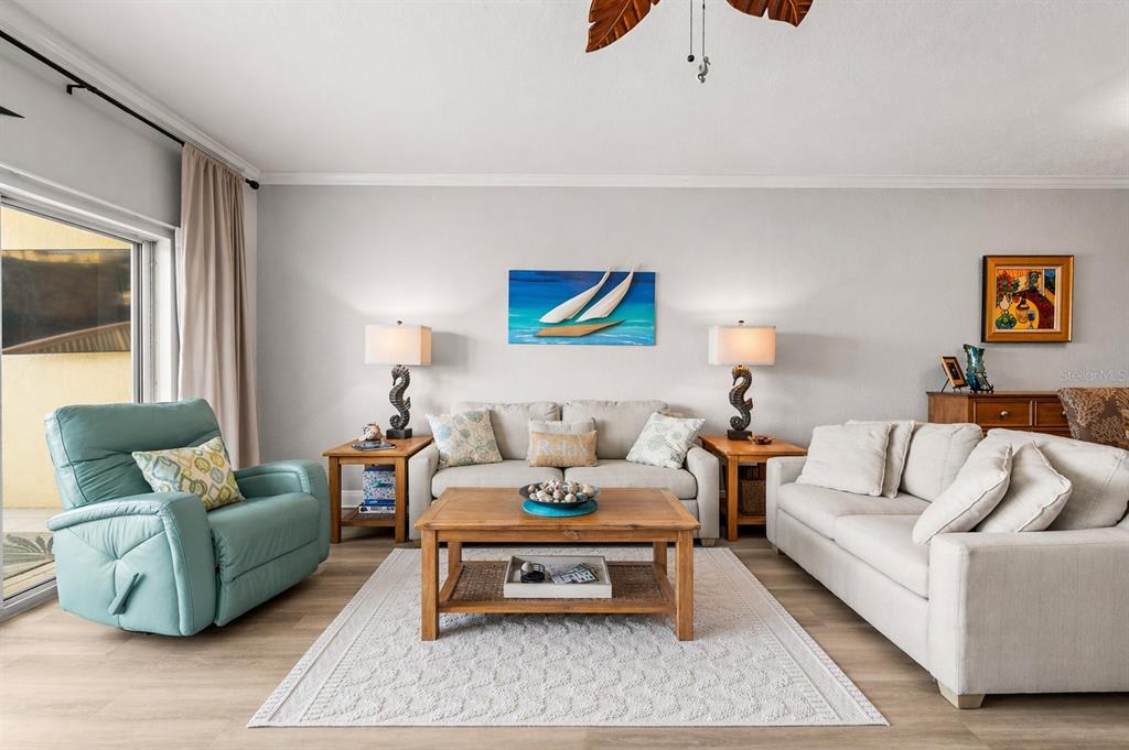 425 150th Avenue, Unit 2303 Madeira Beach, FL 33708 - Photo 18 of 69 a living room with furniture and a flat screen tv