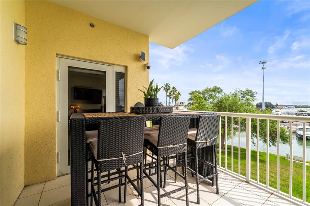 425 150th Avenue, Unit 2303 Madeira Beach, FL 33708 - Photo 23 of 69 a view of a balcony with furniture