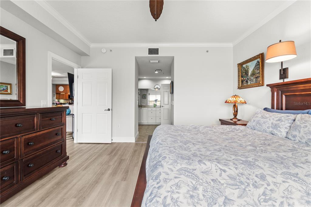 425 150th Avenue, Unit 2303 Madeira Beach, FL 33708 - Photo 32 of 69 a bedroom with a bed and wooden floor