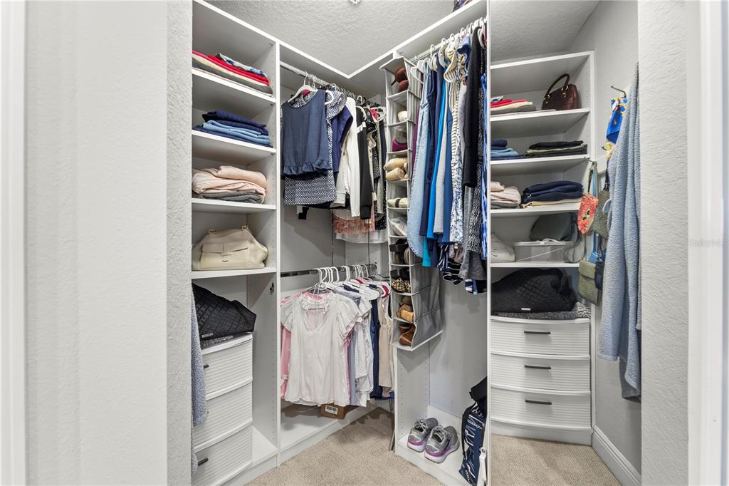 425 150th Avenue, Unit 2303 Madeira Beach, FL 33708 - Photo 41 of 69 a view of walk in closet with clothes and shoes