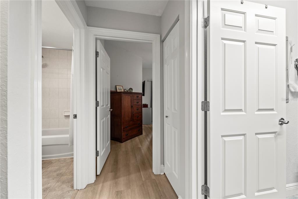 425 150th Avenue, Unit 2303 Madeira Beach, FL 33708 - Photo 43 of 69 a view of a hallway with wooden floor
