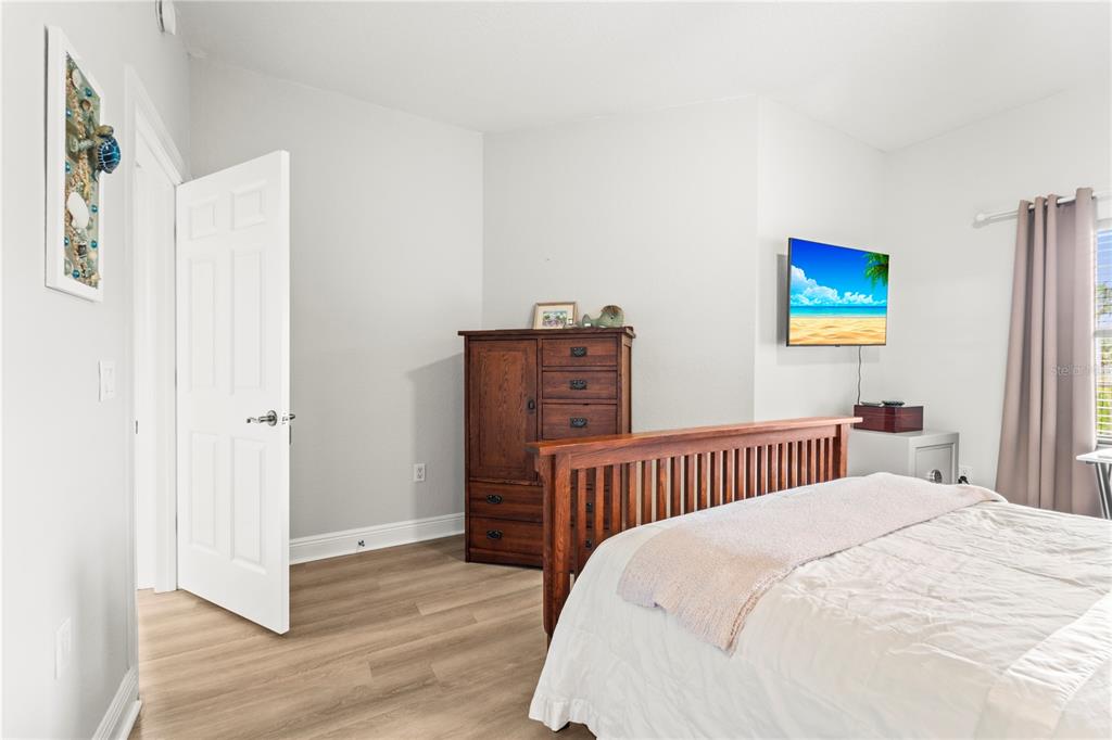 425 150th Avenue, Unit 2303 Madeira Beach, FL 33708 - Photo 45 of 69 a bedroom with a bed and a painting on the wall