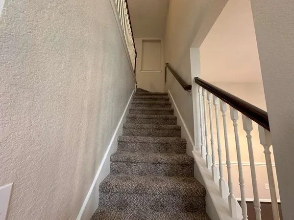 a view of a hallway with entryway door