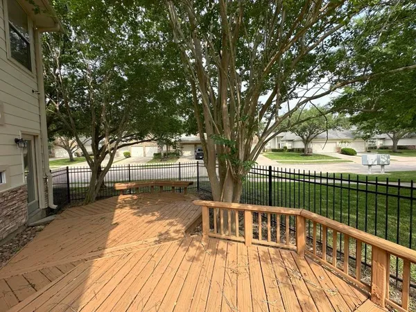 a view of a wooden deck with a yard