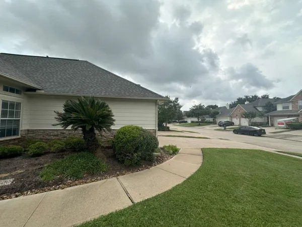 a view of house with yard and garage