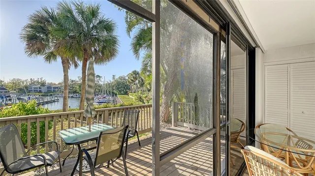 a living room with furniture and a dining table with projector
