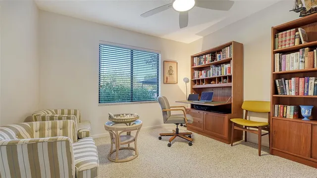 a view of a house with a small yard and wooden floor and fence
