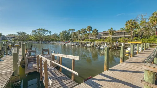 a view of a lake with boats and trees in the background