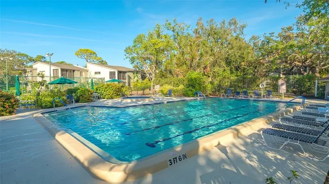 an aerial view of a city with lots of residential buildings ocean and mountain view in back