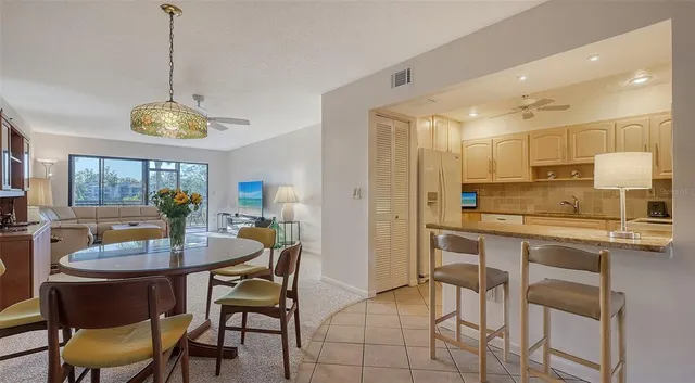 a living room with furniture a chandelier and a flat screen tv