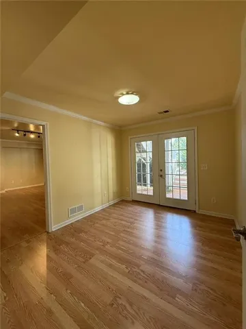 wooden floor in an empty room with a window