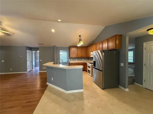 a view of kitchen with refrigerator and microwave