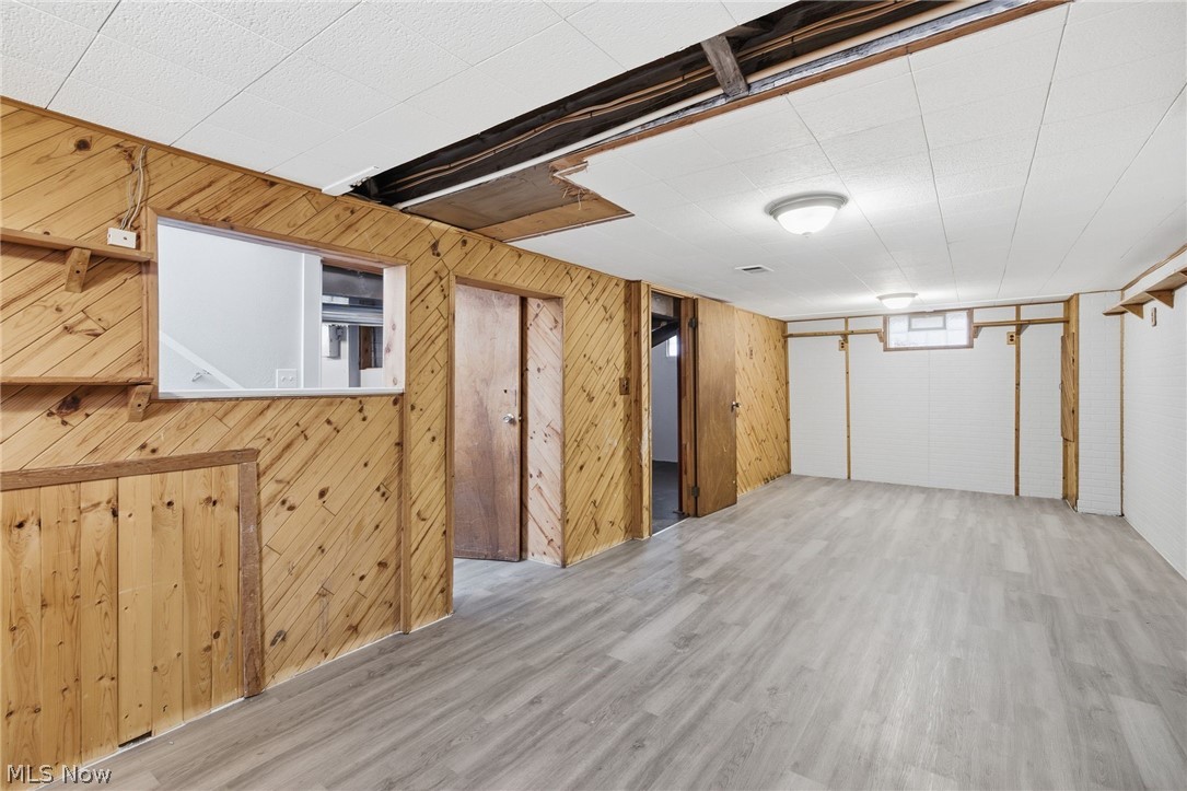 20705 Hansen Road Maple Heights, OH 44137 - Photo 21 of 24 Finished basement featuring wood finished floors and wood walls